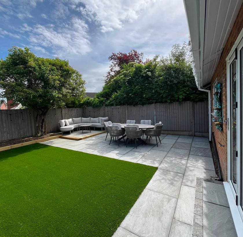 Landscaped garden with artificial lawn, patio and seating